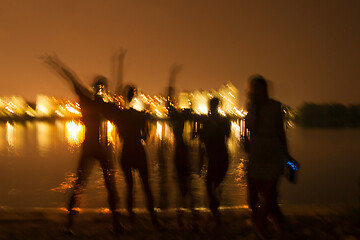 Image showing People silhouettes on the night beach