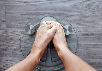 Image showing Human feet on electronic scales