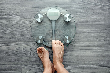 Image showing Human feet on electronic scales