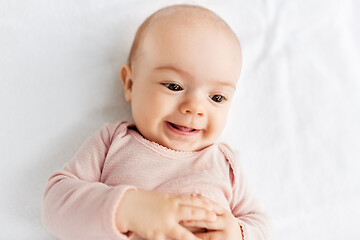 Image showing sweet baby girl lying on white blanket