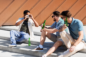 Image showing man photographing friends drinking beer on street