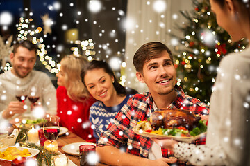 Image showing happy friends having christmas dinner at home