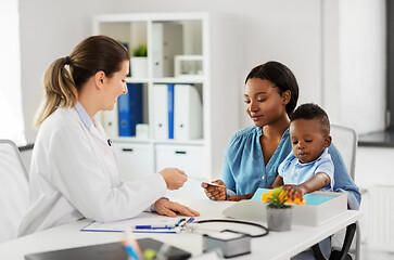 Image showing happy mother with baby son and doctor at clinic