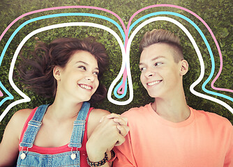 Image showing happy teenage couple lying on grass at summer