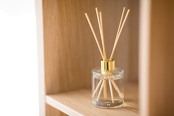 Image showing aroma reed diffuser on wooden shelf