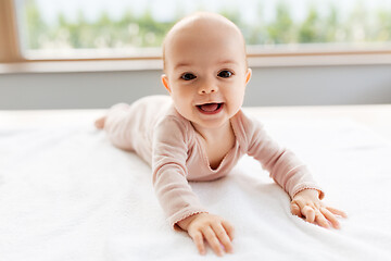 Image showing sweet baby girl lying on white blanket