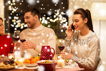 Image showing happy friends having christmas dinner at home