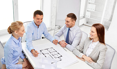 Image showing happy business team discussing blueprint at office