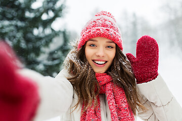 Image showing smiling woman taking selfie outdoors in winter