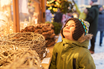 Image showing happy little boy at christmas market in winter