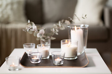 Image showing burning fragrance candles on table at cozy home