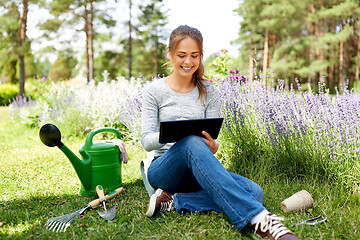 Image showing woman with tablet pc and garden tools in summer