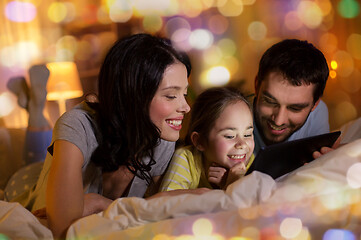 Image showing family with tablet pc in bed at night at home