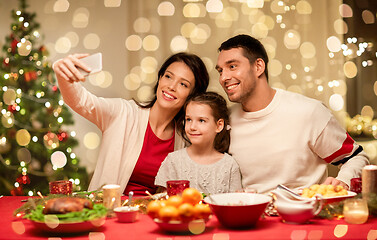 Image showing happy family taking selfie at christmas dinner