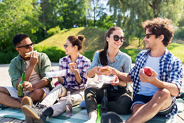 Image showing happy friends having picnic at summer park