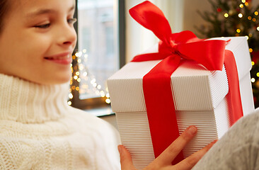 Image showing happy beautiful girl with christmas gift at home