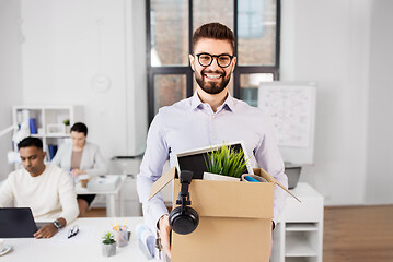 Image showing happy male office worker with personal stuff