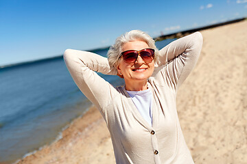 Image showing portrait of senior woman in sunglasses on beach