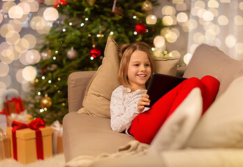 Image showing smiling girl with tablet pc at christmas home