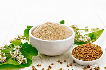 Image showing Flour buckwheat brown in bowl on light board