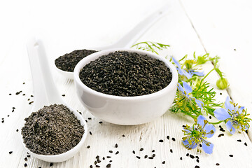 Image showing Seeds of black cumin in bowl on board