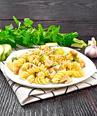 Image showing Fusilli with chicken and zucchini in plate on linen napkin