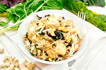 Image showing Funchoza with chard and cashew in bowl on napkin