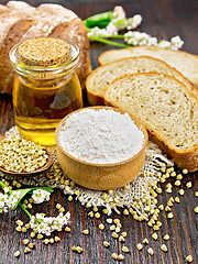 Image showing Flour buckwheat green in bowl with bread on dark wooden board