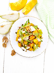 Image showing Salad of pumpkin and pear in plate on light board top