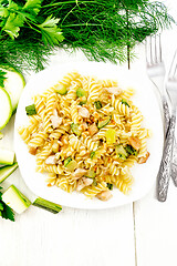 Image showing Fusilli with chicken and zucchini in plate on light board top