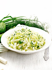 Image showing Salad of cabbage with cucumber in plate on white board