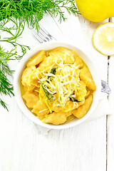 Image showing Gnocchi pumpkin with lemon in bowl on board top