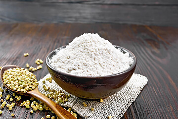 Image showing Flour buckwheat green in bowl on dark board