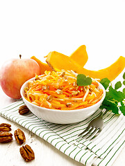 Image showing Salad of pumpkin and apple in bowl on white board