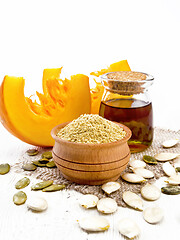 Image showing Flour pumpkin in bowl on light wooden board