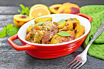 Image showing Turkey with peaches in pan on board