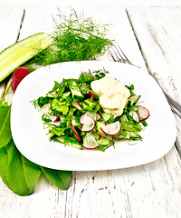 Image showing Salad with radishes and sorrel in plate on table