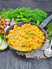 Image showing Goulash with tomato and zucchini in pan on black board