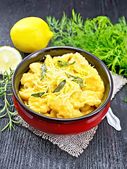 Image showing Gnocchi pumpkin with sage in bowl on dark wooden board