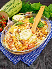 Image showing Zucchini baked with tomatoes in glass pan on table