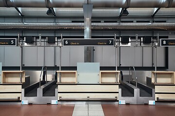 Image showing Check-in counters and baggage conveyors at an airport