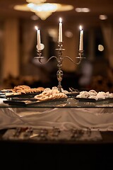 Image showing Candles and cookies in an elegant saloon