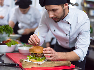 Image showing chef finishing burger