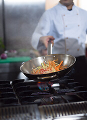 Image showing Chef doing flambe on food