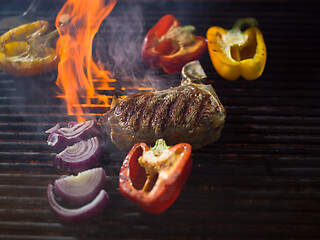 Image showing steak with vegetables on a barbecue