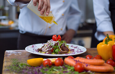 Image showing Chef finishing steak meat plate