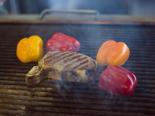 Image showing steak with vegetables on a barbecue