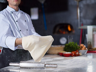 Image showing chef throwing up pizza dough