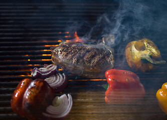 Image showing steak with vegetables on a barbecue