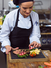 Image showing female Chef preparing beef steak